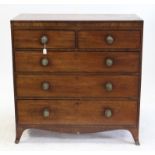 Early 19th century mahogany and ebony strung chest of drawers, the crossbanded top over two short