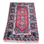 Turkish Dosemealti woollen rug, three pole medallions on a red ground within geometric and floral