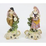 A pair of early 19th century Derby figures as male and female Musicians, brightly decorated in