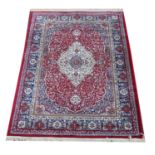 Kashmir rug, with full pile red ground and Shahbaz medallion design, 170 x 120 cm