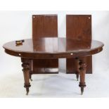 Mahogany wind-out extending oval topped dining table, with two extra leaves, on turned legs and