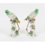 Pair of Samson Parrots, in green with gilding, seated on tree stumps, gold anchor marks, 17 cm high