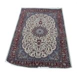 Persian Isfahan rug, with central floral medallion and scrolling floral design on a cream ground,