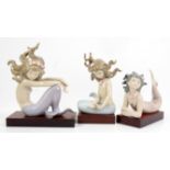 Three Lladro figures of mermaids, numbers 1415, 1413, 1414, with wood bases and original boxes