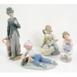 Lladro figure of a boy playing with a train, No 7619, and three other Lladro figures, Nos.