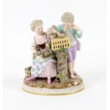 19th century Dresden porcelain figure group of two children nesting chicks out of a cage,