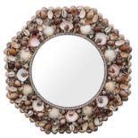 A shell encrusted octagonal wall mirror, with circular plate, and symmetric design on shells,