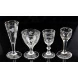 Four 18th and 19th century drinking glasses with engraved bowls on round feet, tallest 15cm,