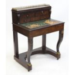 Early 19th century mahogany and brass inlaid writing desk, the brass gallery over an arrangement of