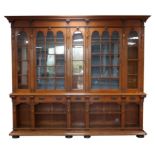 Mid Victorian oak bookcase, with strapwork carving, the protruding cornice over two triple arched
