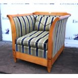 Cherrywood deep bergere armchair, Regency style with blue stripe upholstery, the outswept arms on