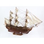 Scratch built timber model of HMS Victory, fully rigged and drawing it's sails, with label on the