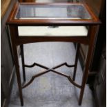 An early 20th century mahogany and satinwood crossbanded bijouterie table with hinged lid on square