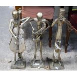Trio of silvered brass figures of a three piece band, playing trumpet, double bass and saxophone