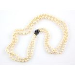 An Edwardian two row pearl necklace, two graduated rows of cream pearls, measuring from 4.7-9.