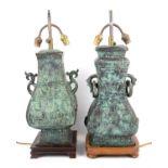 Pair of Chinese bronze table lamps, of square baluster form with ring handles, 42 cm high
