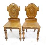 Pair of Victorian mahogany hall chairs, the shield shape backs over solid seats on turned legs (2)
