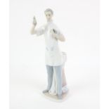 Lladro Figure of a dentist, holding up a tooth with pliers, H36 cm