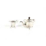Silver teapot and milk jug, of cylindrical form with beaded edge, (handle on teapot detached),