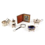 Pair of lorgnette, 11.5 cm long, a three piece silver condiment set, a pair of napkin rings and a