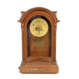 An early 20th century mahogany arched case mantel clock, by Howell & James Ltd. with fluted