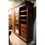 Mid Victorian mahogany compactum wardrobe, the mirrored central door flanked by panelled doors