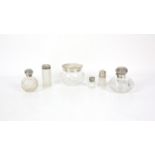 Four cut glass and silver topped scent bottles of various sizes and hallmarks, largest 9.5cm high,