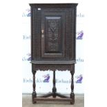 Carved oak corner cupboard on stand, with foliate, floral and lunette carving, on turned supports,