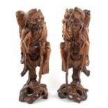 A pair of Taoist Chinese wooden sculptures representing  The immortal Li Tieguai.  34 cm High