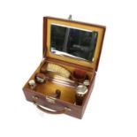 Gentleman's brown leather dressing case, the interior fitted with a mirror, two silver topped