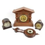 An early 20th century oak architectural form mantel clock, H33 cm, a barrel shaped clock, H18 cm,