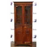 Late Victorian Art Nouveau style bookcase cabinet, with brass hinges, lead glazed doors over a pair