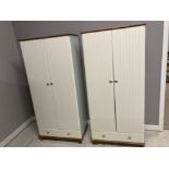 A PAIR OF MODERN CREAM LAMINATE AND PINE WARDROBES HANGING SPACE ABOVE A SINGLE DRAWER 84 X 181 X