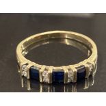 18CT YELLOW GOLD BLACK SAPPHIRE AND DIAMOND BAND COMPRISING OF THREE PRINCESS CUT BLACK SAPPHIRES