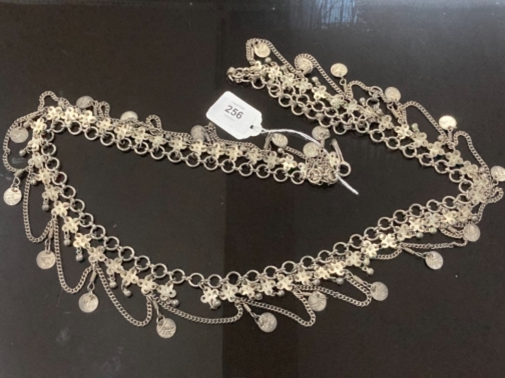 A MIDDLE EASTERN SILVER COLOURED METAL BELLY DANCER BELT