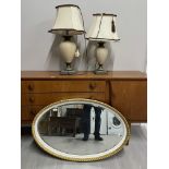 A NEAR PAIR OF TABLE LAMPS AND PAINTED ROPE EDGED OVAL SHAPED MIRROR 49 X 84 CM