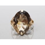 9CT YELLOW GOLD SMOKEY QUARTZ RING COMPRISING OF A SINGLE OVAL SMOKEY QUARTZ STONE SET IN A 4 CLAW