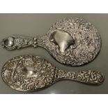 TWO HEAVILY EMBOSSED SILVER HAND MIRRORS THE SMALLER HALLMARKED FOR SHEFFIELD 1936 BY WALKER AND