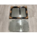 A FRAMELESS BEVELLED WALL MIRROR 69 X 41CM AND ANOTHER IN A BLACK AND GILT FRAME 73 X 64CM