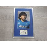 FRAMED AND MOUNTED PHOTOGRAPH OF DIEGO MARADONA WITH SIGNATURE BELOW
