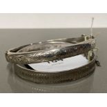 TWO SILVER CUFF BANGLES ONE HALF ETCHED FERN DESIGN HALLMARKED FOR SMITH AND EWAN CHESTER 1958