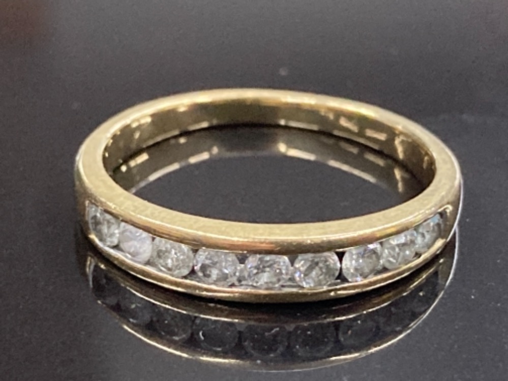18CT YELLOW GOLD AND DIAMOND HALF ETERNITY RING COMPRISING OF NINE ROUND BRILLIANT CUT DIAMONDS IN A
