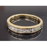 18CT YELLOW GOLD AND DIAMOND HALF ETERNITY RING COMPRISING OF NINE ROUND BRILLIANT CUT DIAMONDS IN A