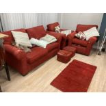 A MODERN THREE PIECE SUITE COMPRISING A TWO SEATER SOFA PAIR OF ARMCHAIRS AND MATCHING FOOTSTOOLS