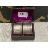 CASED PAIR OF OVAL SILVER NAPKIN RINGS ENGINE TURNED WITH INSCRIBED CARTOUCHES AND HALLMARKED FOR
