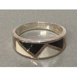 A SILVER OYNX AND MOTHER OF PEARL BAND RING SIZE Q 4.2G GROSS