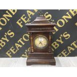 A REPRODUCTION MANTLE CLOCK WITH BRASS MOUNTS AND ROMAN DIAL 52CM HIGH OVERALL