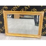 A MODERN BEVELLED WALL MIRROR IN GOLT FRAME 64 X 90CM