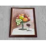 A FRAMED OIL PAINTING ON BOARD OF FRUIT AND WINE SIGNED BY D AINSLEY