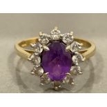 9CT GOLD OVAL PURPLE STONE RING SURROUNDED BY 12 CZ WITH CLAW SETTING SIZE M1/2 2.6G